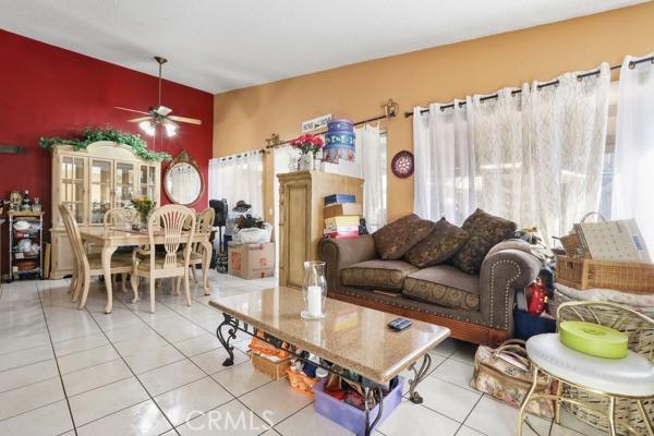 3805 Eisenhower Dr, Lake Elsinore, CA 92530 - tiled living room featuring plenty of natural light and a ceiling fan