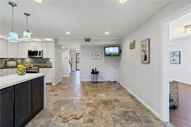 1879 N Nordic Pl, Orange, CA 92865 - kitchen with stainless steel appliances, white cabinetry, stone tile flooring, baseboards, and crown molding