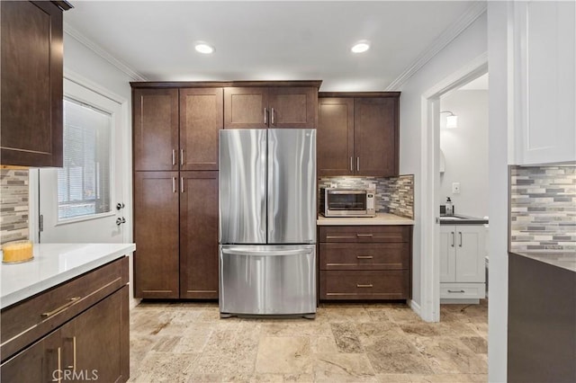 1879 N Nordic Pl, Orange, CA 92865 - kitchen featuring freestanding refrigerator, tasteful backsplash, crown molding, light countertops, and dark brown cabinets