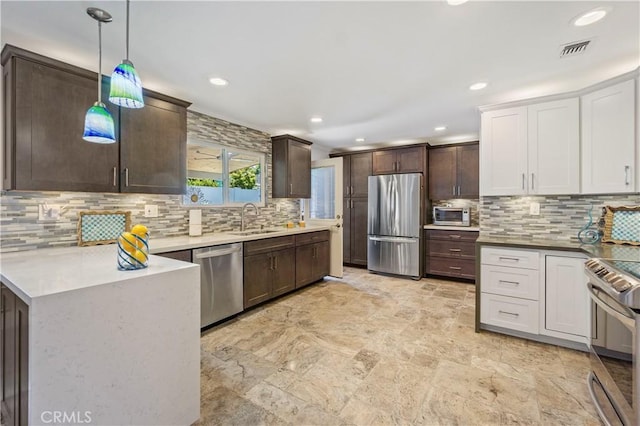 1879 N Nordic Pl, Orange, CA 92865 - kitchen featuring appliances with stainless steel finishes, dark brown cabinetry, tasteful backsplash, hanging light fixtures, and recessed lighting