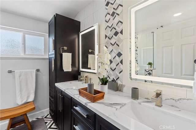 1879 N Nordic Pl, Orange, CA 92865 - bathroom featuring double vanity, decorative backsplash, and baseboards
