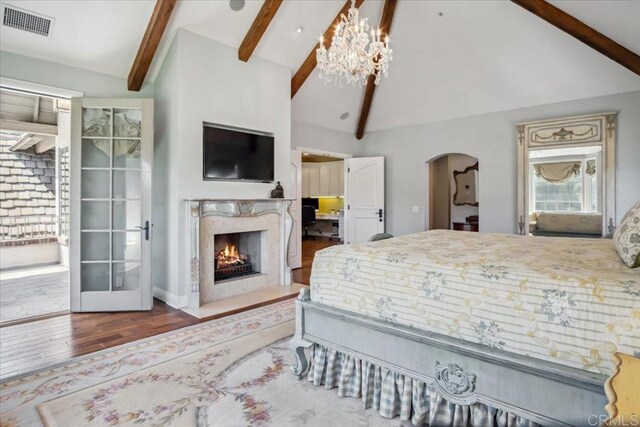 16056 Avenida Calma, Rancho Santa Fe, CA 92091 - bedroom with wood finished floors, arched walkways, and a fireplace