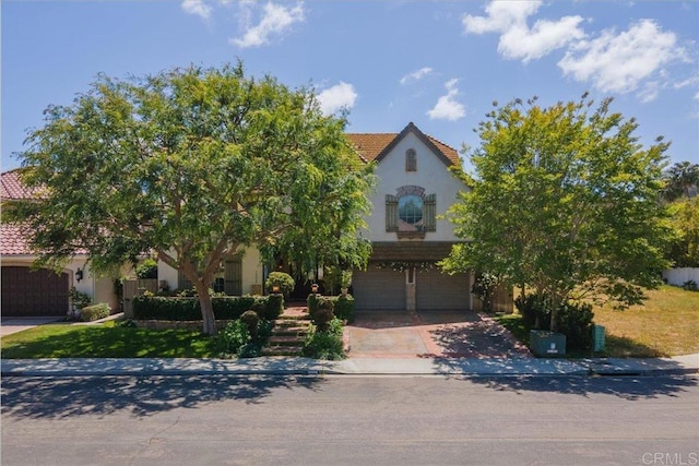 16056 Avenida Calma, Rancho Santa Fe, CA 92091 - view of front of house with an attached garage, a tile roof, concrete driveway, and stucco siding