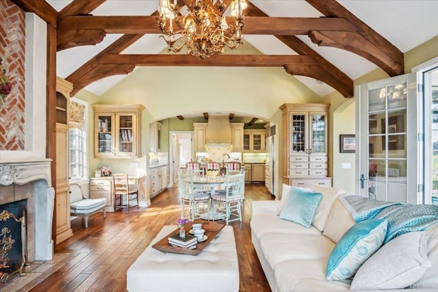 16056 Avenida Calma, Rancho Santa Fe, CA 92091 - living room featuring arched walkways, a chandelier, light wood-style flooring, and a fireplace with flush hearth