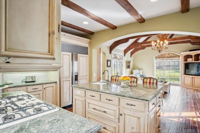 16056 Avenida Calma, Rancho Santa Fe, CA 92091 - kitchen featuring arched walkways, white gas stovetop, cream cabinets, paneled refrigerator, and recessed lighting