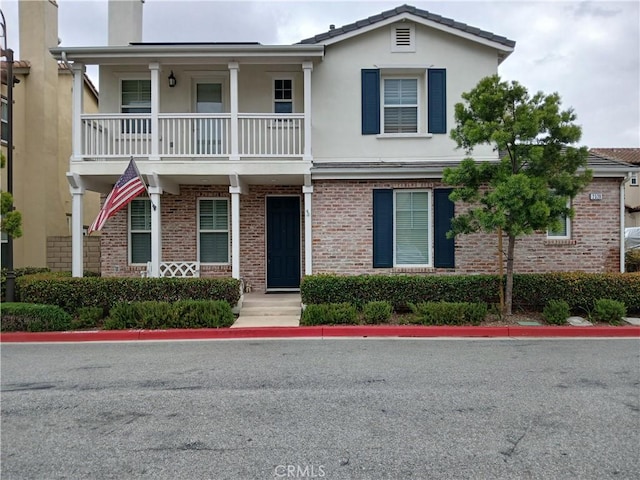 2520 Cornerstone Ln, Costa Mesa, CA 92626 - multi unit property featuring brick siding, a balcony, stucco siding, and a chimney