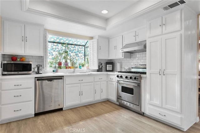 18060 Pebble Beach Dr, Victorville, CA 92395 - kitchen with appliances with stainless steel finishes, under cabinet range hood, a sink, white cabinetry, and recessed lighting