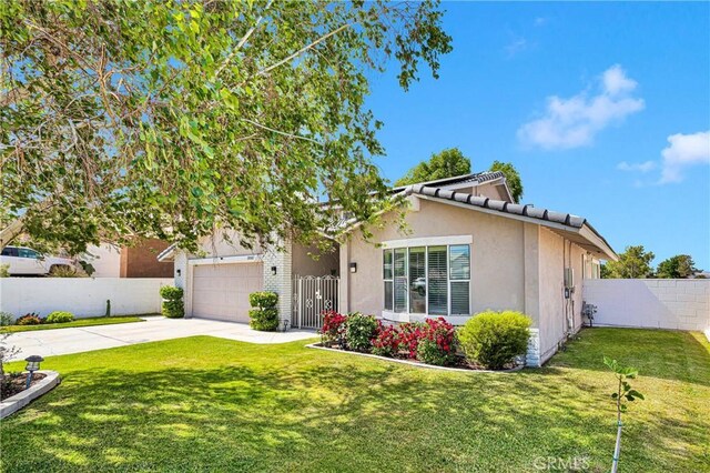 18060 Pebble Beach Dr, Victorville, CA 92395 - view of front of property featuring concrete driveway, stucco siding, and a tiled roof