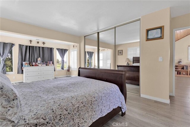18060 Pebble Beach Dr, Victorville, CA 92395 - bedroom with baseboards, wood finished floors, and a closet