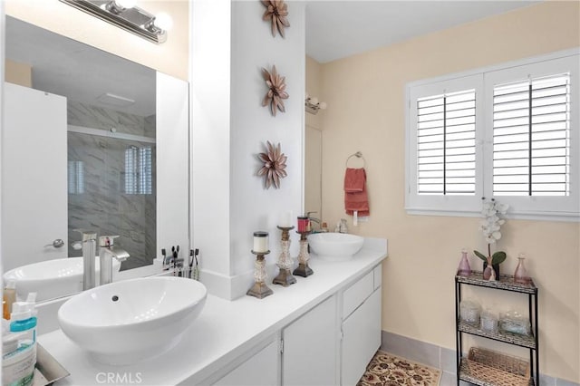 18060 Pebble Beach Dr, Victorville, CA 92395 - bathroom featuring a shower stall, double vanity, tile patterned flooring, and baseboards