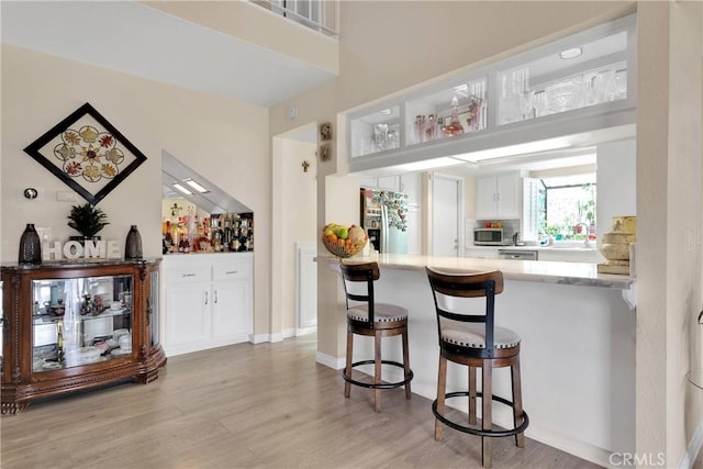 18060 Pebble Beach Dr, Victorville, CA 92395 - kitchen featuring light wood-type flooring, appliances with stainless steel finishes, white cabinetry, and light countertops
