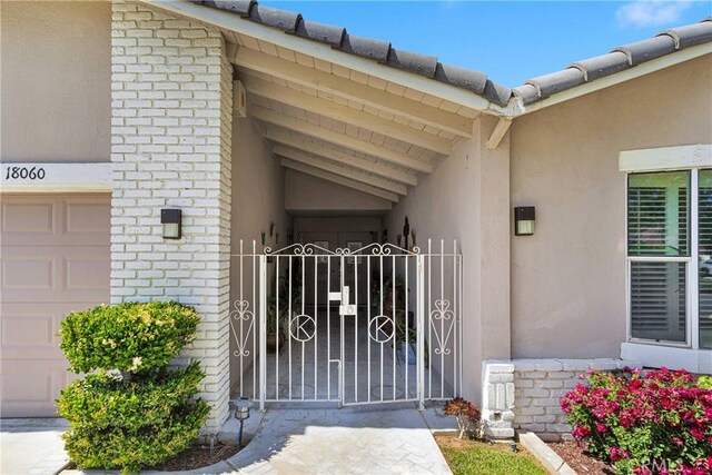 18060 Pebble Beach Dr, Victorville, CA 92395 - entrance to property featuring stucco siding and a gate
