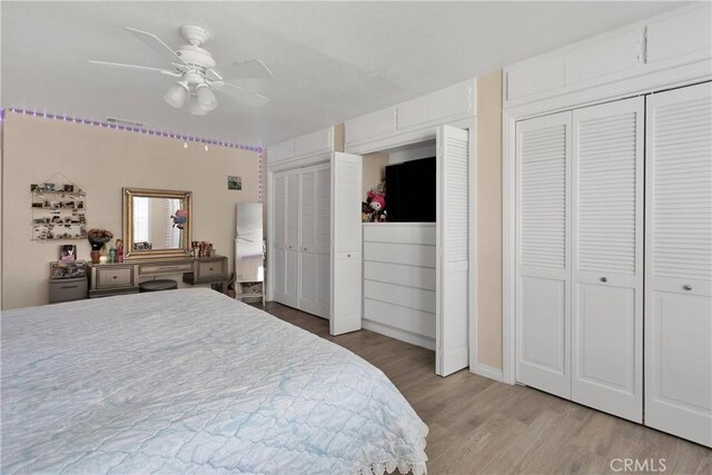 18060 Pebble Beach Dr, Victorville, CA 92395 - bedroom with two closets, light wood-type flooring, and a ceiling fan