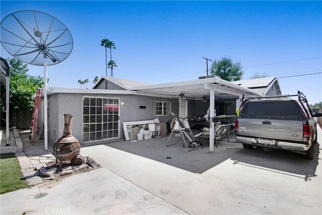 615 S Hewitt St, San Jacinto, CA 92583 - back of house featuring a ceiling fan, a patio area, and stucco siding