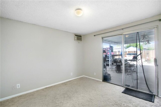 615 S Hewitt St, San Jacinto, CA 92583 - carpeted empty room with a wall mounted AC and a textured ceiling