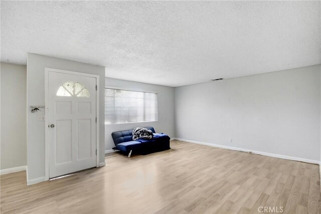 615 S Hewitt St, San Jacinto, CA 92583 - entrance foyer featuring light wood finished floors and a textured ceiling