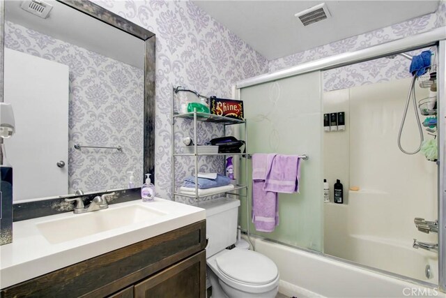 615 S Hewitt St, San Jacinto, CA 92583 - bathroom featuring wallpapered walls, vanity, and shower / bath combination with glass door