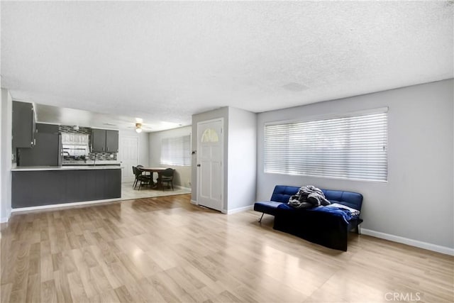 615 S Hewitt St, San Jacinto, CA 92583 - living room with light wood-style floors, ceiling fan, and a textured ceiling