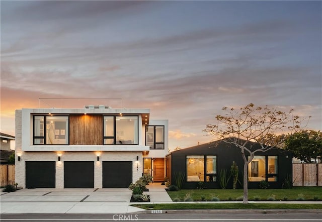1235 Santiago Dr, Newport Beach, CA 92660 - modern home featuring an attached garage, concrete driveway, and a balcony