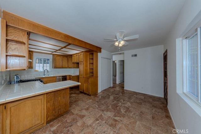 kitchen featuring stainless steel dishwasher, tile countertops, open shelves, a ceiling fan, and a peninsula