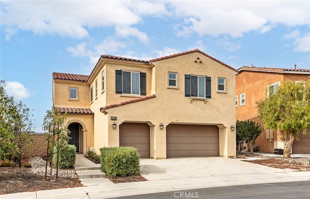 24449 Payton Dr, Lake Elsinore, CA 92532 - mediterranean / spanish-style house with an attached garage, a tiled roof, stucco siding, and concrete driveway