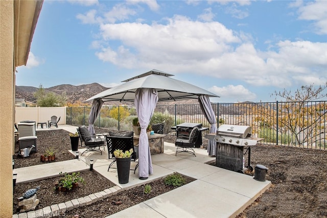 24449 Payton Dr, Lake Elsinore, CA 92532 - view of patio / terrace featuring a fire pit, a gazebo, area for grilling, a mountain view, and a fenced backyard