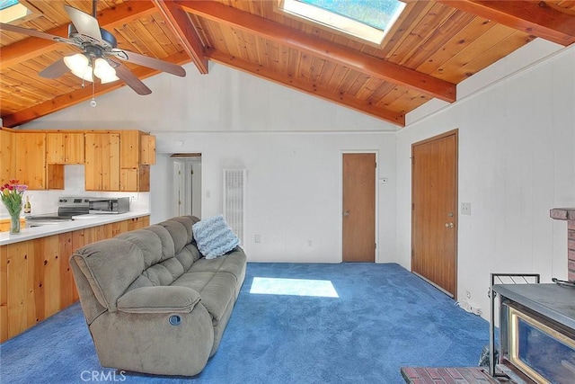 771 Woodland Rd, Crestline, CA 92325 - living room featuring carpet flooring, a skylight, a wood stove, wood ceiling with exposed beams, and a heating unit