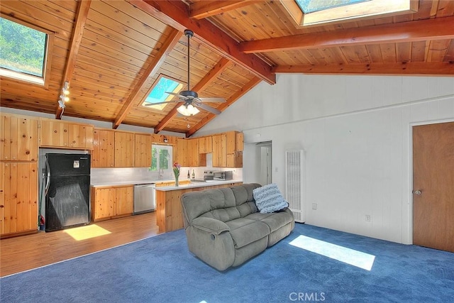 771 Woodland Rd, Crestline, CA 92325 - living room featuring a skylight, a heating unit, light colored carpet, wooden ceiling with exposed beams, and ceiling fan