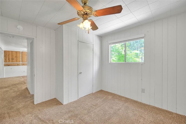 771 Woodland Rd, Crestline, CA 92325 - unfurnished bedroom with carpet floors, wooden walls, and ceiling fan