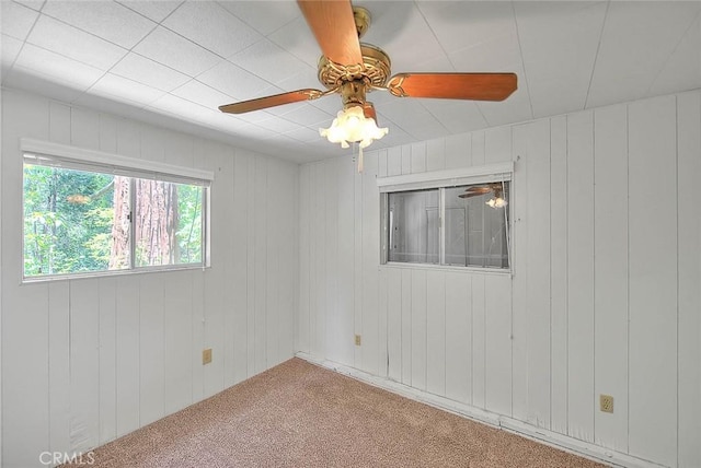 771 Woodland Rd, Crestline, CA 92325 - carpeted spare room featuring a ceiling fan and wood walls
