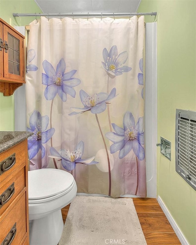 771 Woodland Rd, Crestline, CA 92325 - bathroom with wood finished floors, toilet, vanity, baseboards, and a shower with shower curtain