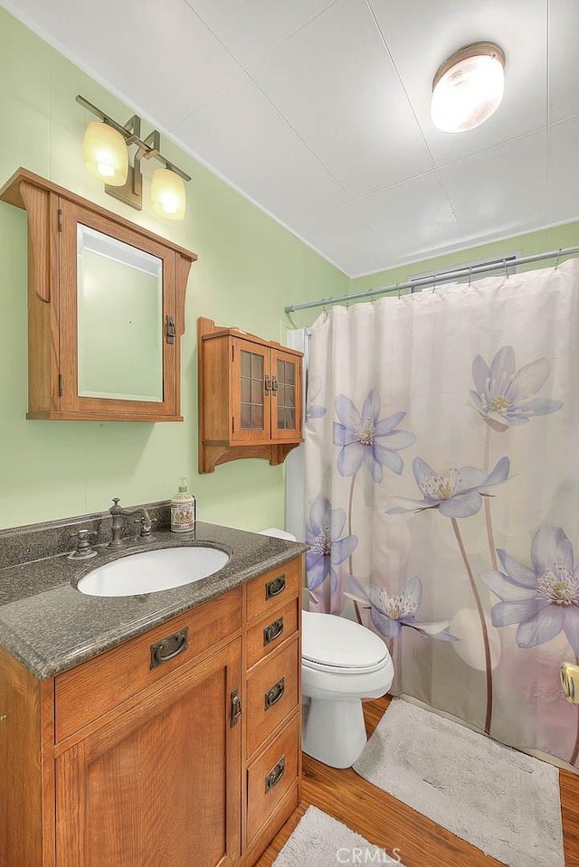 771 Woodland Rd, Crestline, CA 92325 - bathroom featuring wood finished floors, vanity, toilet, and curtained shower