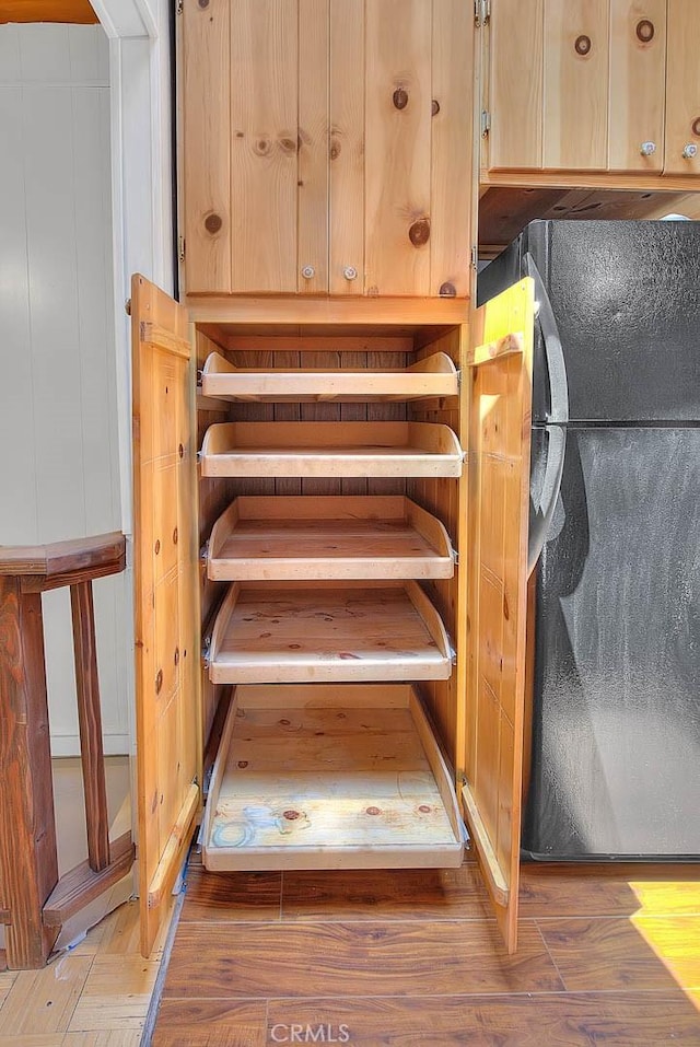 771 Woodland Rd, Crestline, CA 92325 - detailed view of light brown cabinets, freestanding refrigerator, and wood finished floors