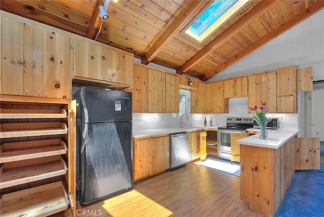 771 Woodland Rd, Crestline, CA 92325 - kitchen featuring stainless steel appliances, a skylight, light brown cabinets, light countertops, and tasteful backsplash