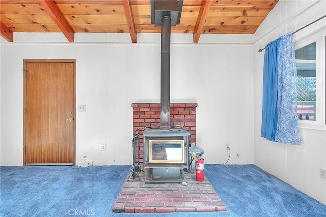 771 Woodland Rd, Crestline, CA 92325 - detailed view of carpet flooring, a wood stove, wood ceiling with exposed beams, and a fire extinguisher