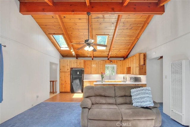 771 Woodland Rd, Crestline, CA 92325 - living area with a heating unit, a skylight, light colored carpet, wood ceiling with exposed beams, and ceiling fan