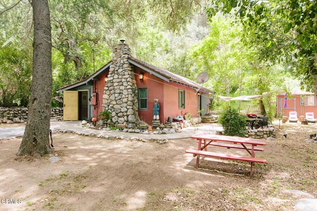 11 N San Gabriel Canyon Rd, Azusa, CA 91702 - view of side of home with a chimney