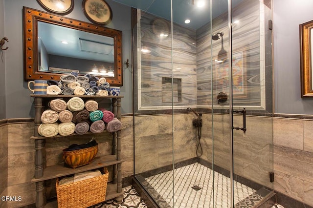 11 N San Gabriel Canyon Rd, Azusa, CA 91702 - bathroom with tile walls, wainscoting, and a stall shower