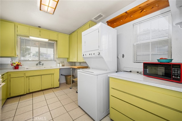 14512 Lefloss Ave, Norwalk, CA 90650 - laundry area with stacked washer / drying machine and light tile patterned floors