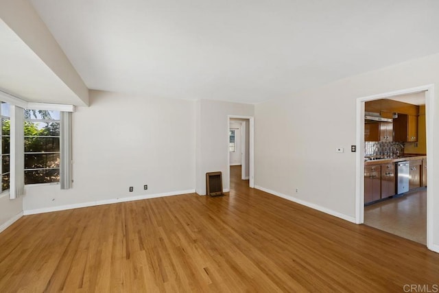 3973 69th St, San Diego, CA 92115 - unfurnished living room with light wood-style floors and baseboards