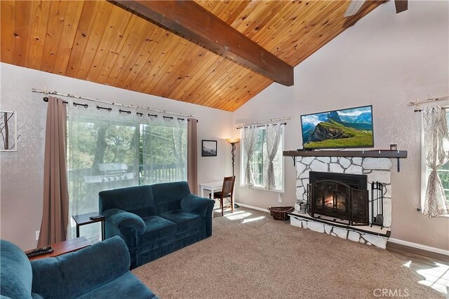 22365 Pine Dr, Cedarpines Park, CA 92322 - living area with beam ceiling, baseboards, a stone fireplace, wood ceiling, and carpet flooring