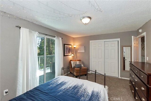 22365 Pine Dr, Cedarpines Park, CA 92322 - carpeted bedroom featuring access to exterior, a textured ceiling, and a closet