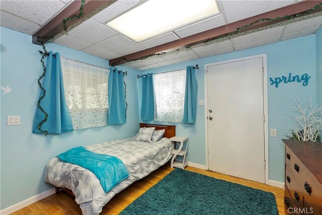 22365 Pine Dr, Cedarpines Park, CA 92322 - bedroom with wood finished floors, baseboards, and a drop ceiling