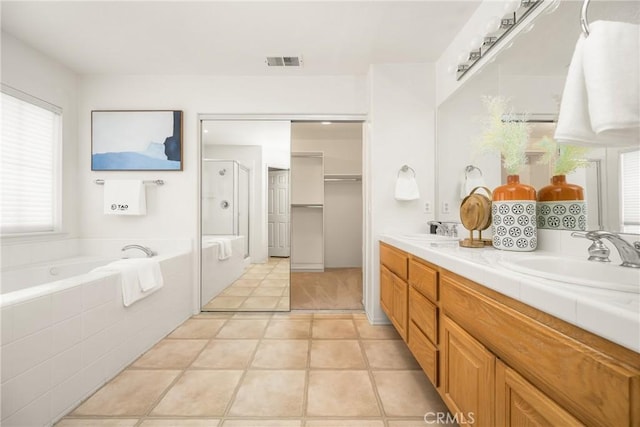 40 Calais, Irvine, CA 92602 - full bathroom featuring a garden tub, double vanity, a stall shower, and tile patterned flooring