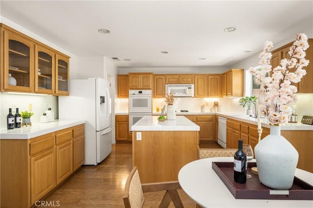40 Calais, Irvine, CA 92602 - kitchen featuring white appliances, a center island, glass insert cabinets, tile counters, and light wood-type flooring