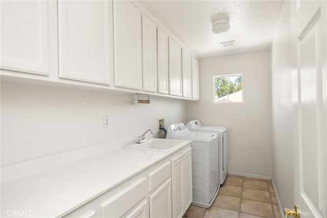 40 Calais, Irvine, CA 92602 - washroom featuring cabinet space, washer and dryer, baseboards, and light tile patterned floors