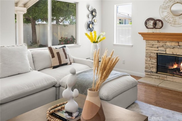 40 Calais, Irvine, CA 92602 - living room with baseboards, wood finished floors, and a stone fireplace