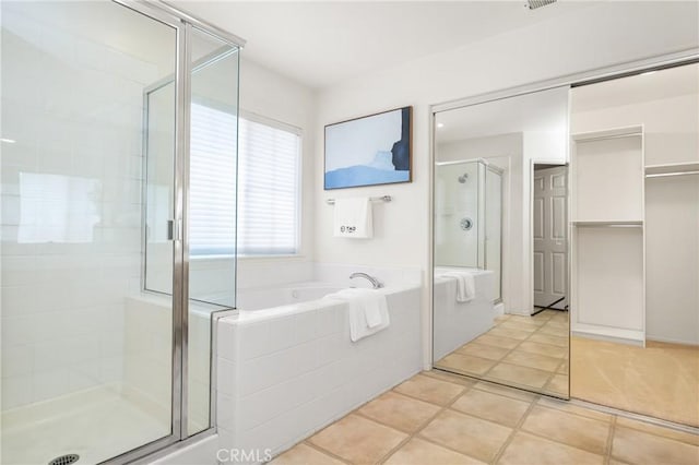 40 Calais, Irvine, CA 92602 - bathroom featuring a shower stall, a garden tub, tile patterned floors, and a spacious closet