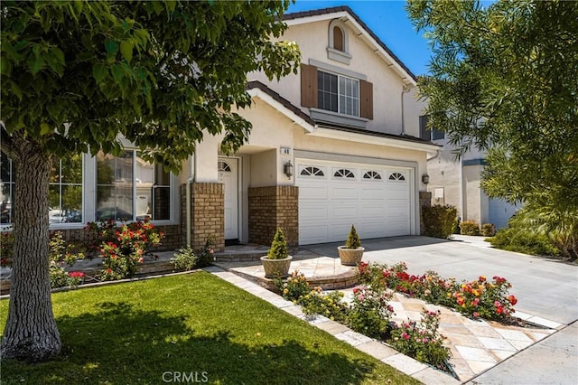 40 Calais, Irvine, CA 92602 - view of front of home featuring stucco siding, a garage, concrete driveway, a front lawn, and brick siding