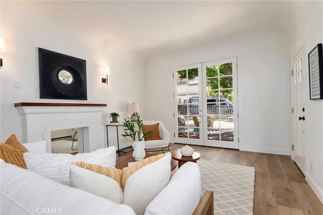 94 E Highland Ave, Sierra Madre, CA 91024 - living room with wood finished floors, baseboards, and a fireplace